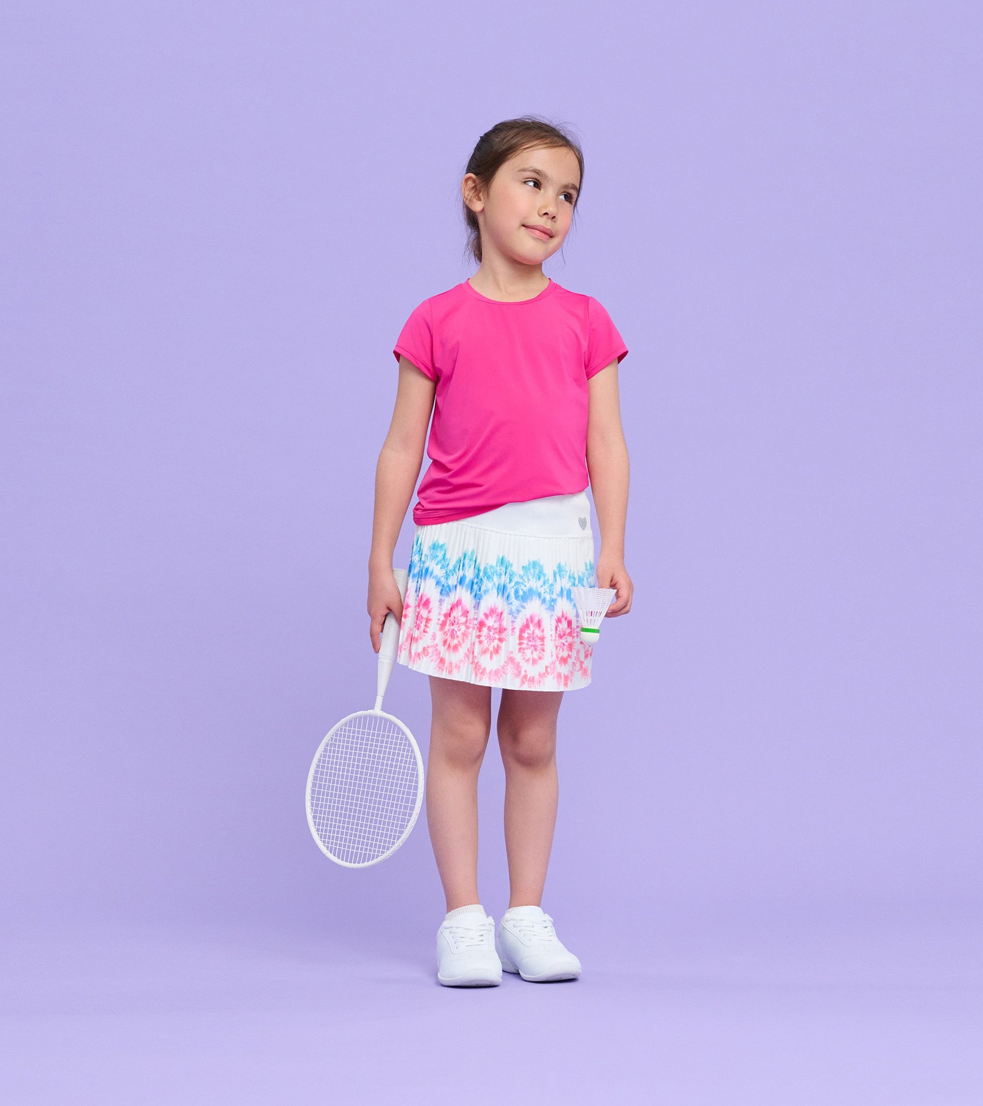 Sporty skort with a colorful floral pattern, paired with a pink top, suitable for active play.