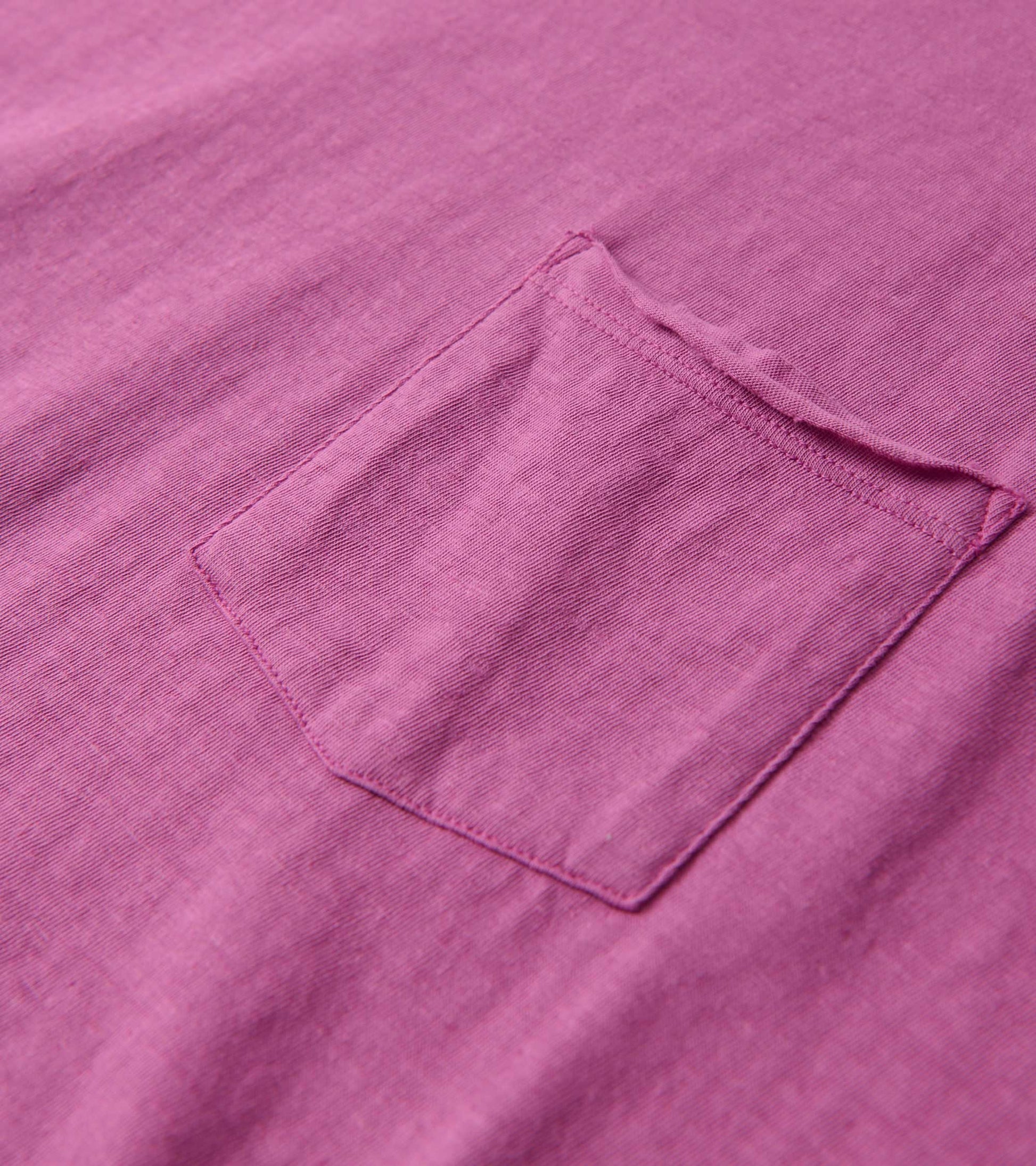 Slouchy tee in orchid color featuring a small pocket, made from soft fabric with a relaxed fit.