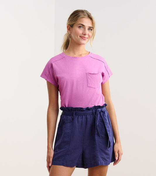 Slouchy orchid tee with short sleeves and a chest pocket, paired with navy shorts.