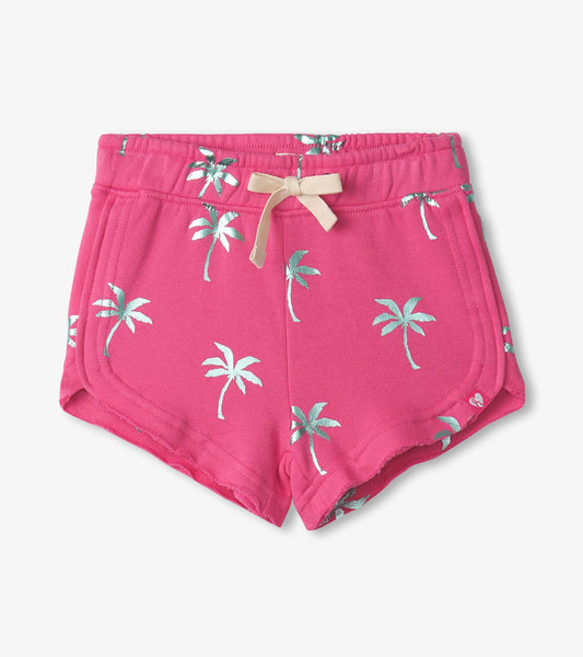 Pink pull-on shorts featuring a palm tree pattern and a decorative bow at the waistband.