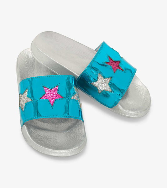 Turquoise slide sandals with shiny star appliqués in pink, silver, and glitter on a silver textured sole.