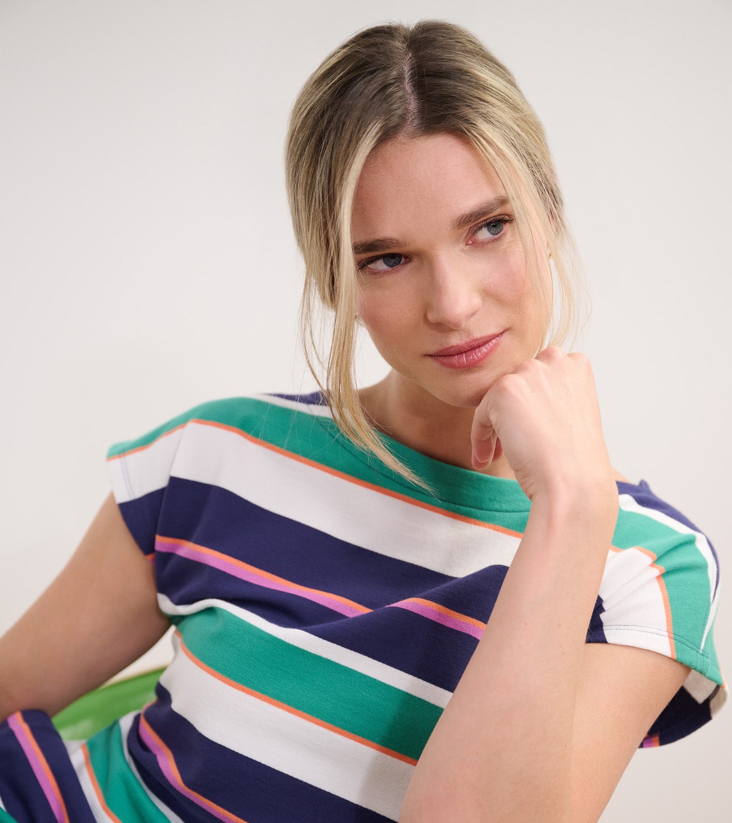 Short-sleeve dress featuring horizontal stripes in green, navy, white, and coral, perfect for casual spring wear.