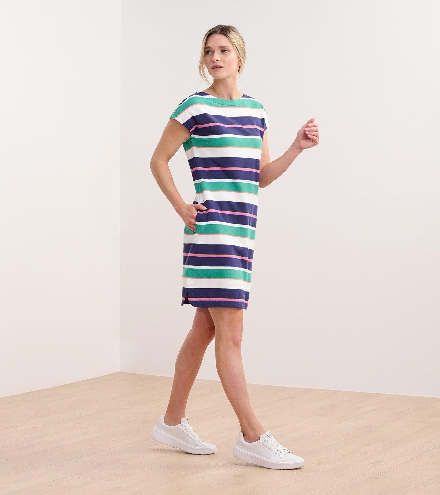 Short-sleeve dress featuring horizontal stripes in green, blue, pink, and white, with side pockets and a relaxed fit.