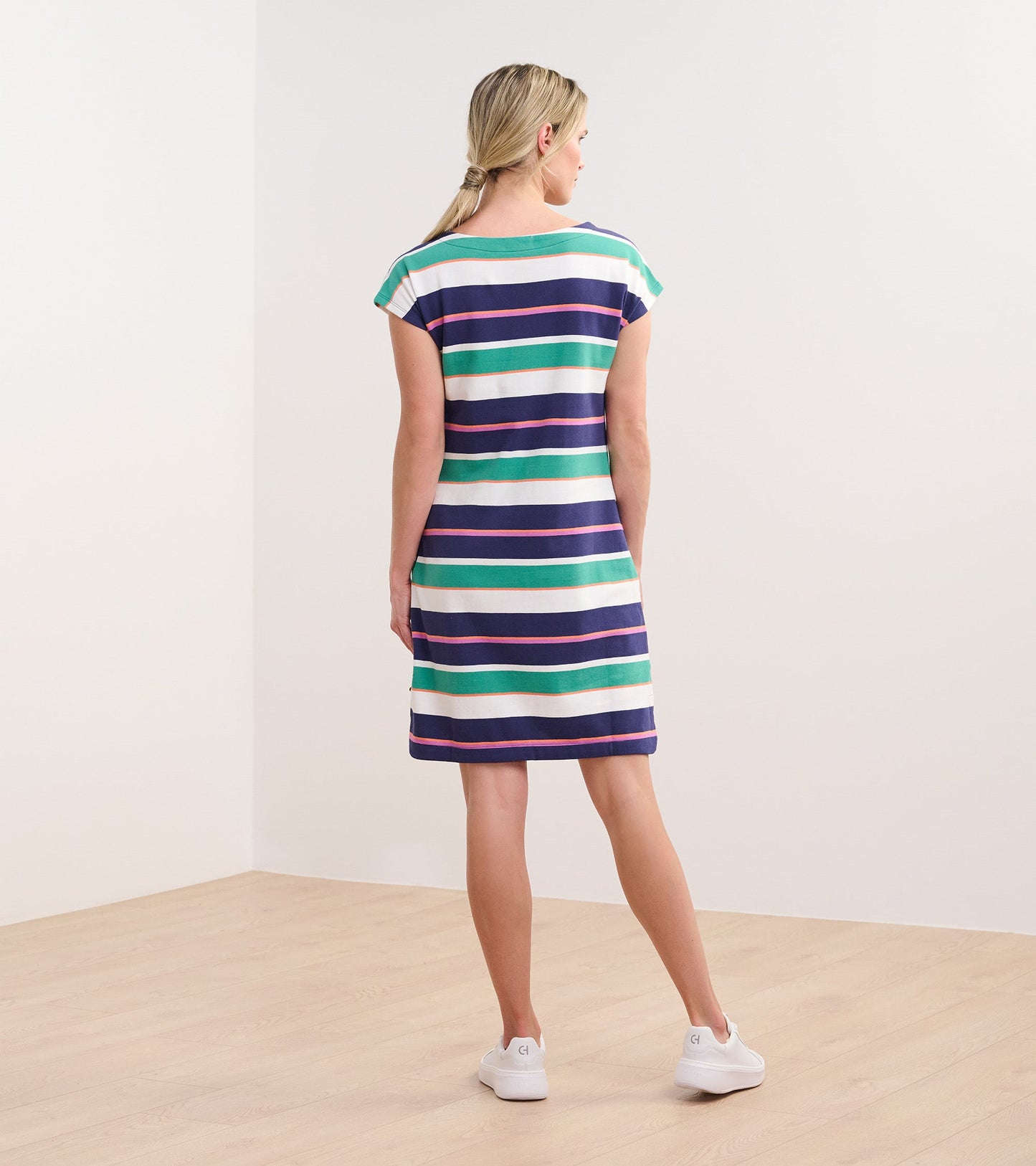 Back view of a knee-length dress featuring horizontal stripes in green, navy, white, and purple, with cap sleeves.