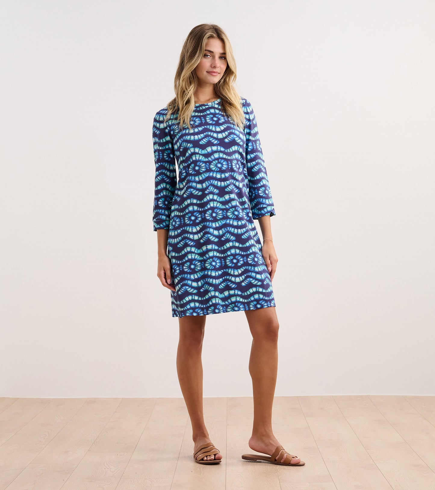 Blue dress with shibori wave pattern, three-quarter sleeves, and a relaxed fit, suitable for casual wear.