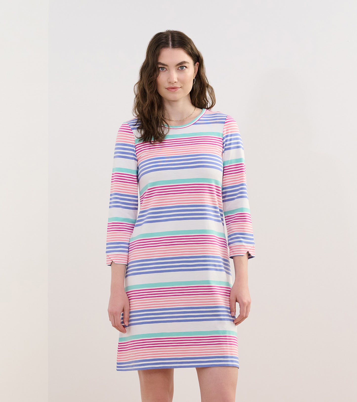Peach dress with colorful horizontal stripes, featuring three-quarter sleeves and a relaxed fit.