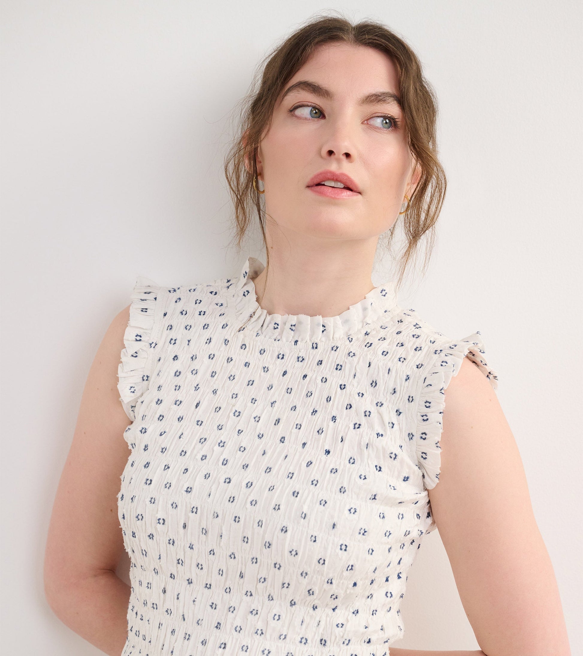 Navy spotted smocked maxi dress with ruffled sleeves and a high neckline, perfect for casual outings.