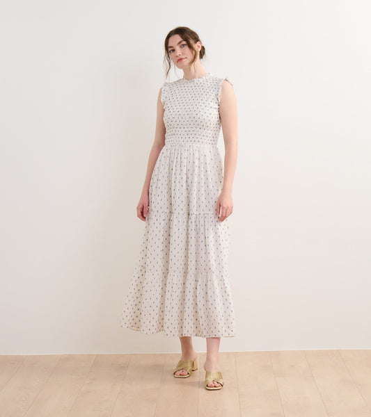 Navy spotted smocked maxi dress with a tiered skirt and ruffled sleeves, perfect for casual outings.