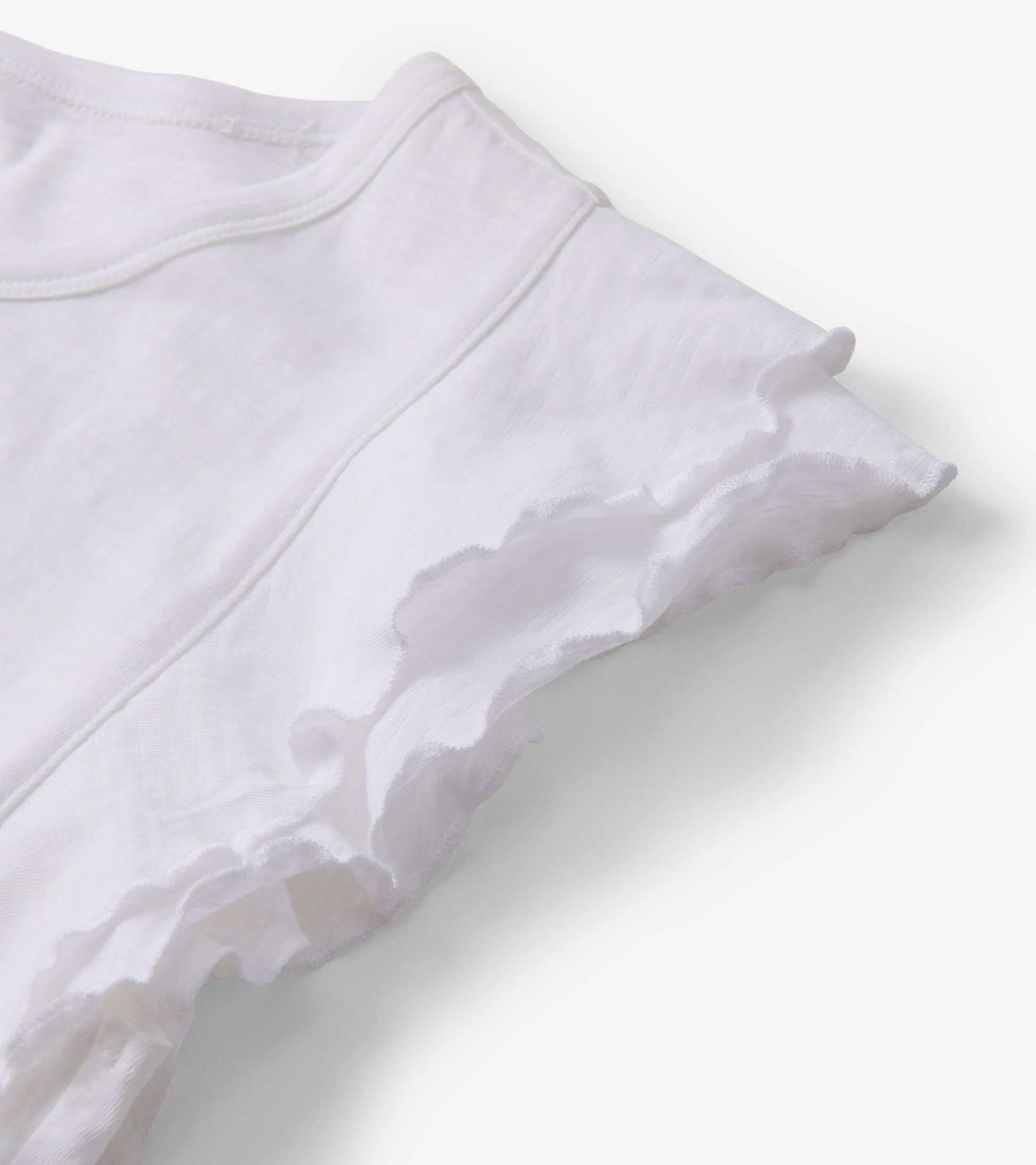 White tank top featuring layered ruffle sleeves, made from lightweight fabric.