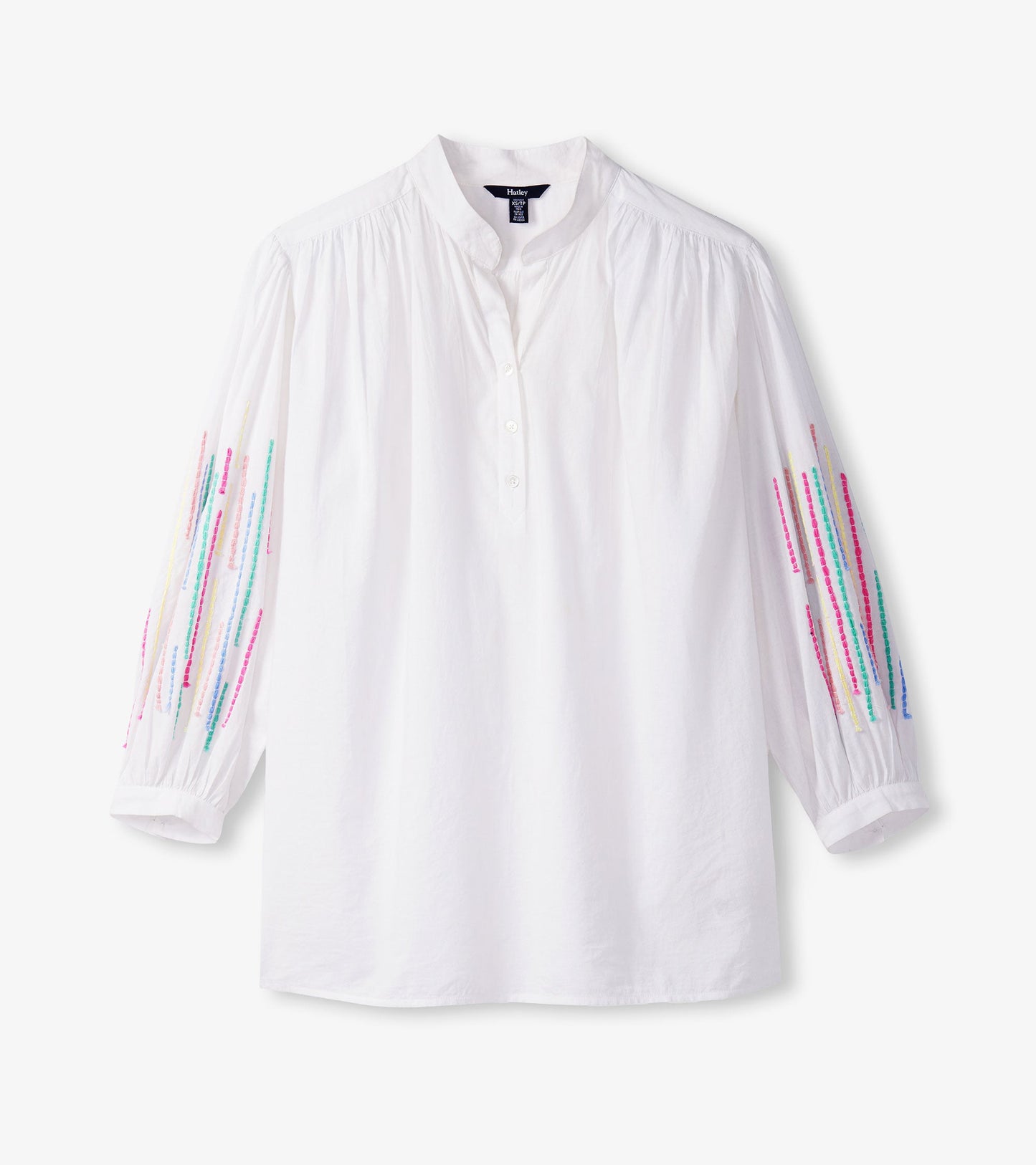 White gauze tunic with colorful embroidered stripes on the sleeves and a buttoned placket.