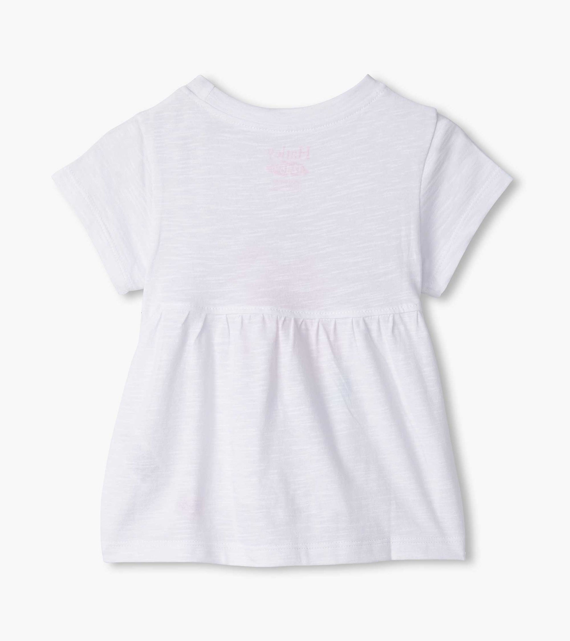 White short-sleeve tee with a gathered waist and glowing hearts graphic on the back. Suitable for baby and toddler girls.