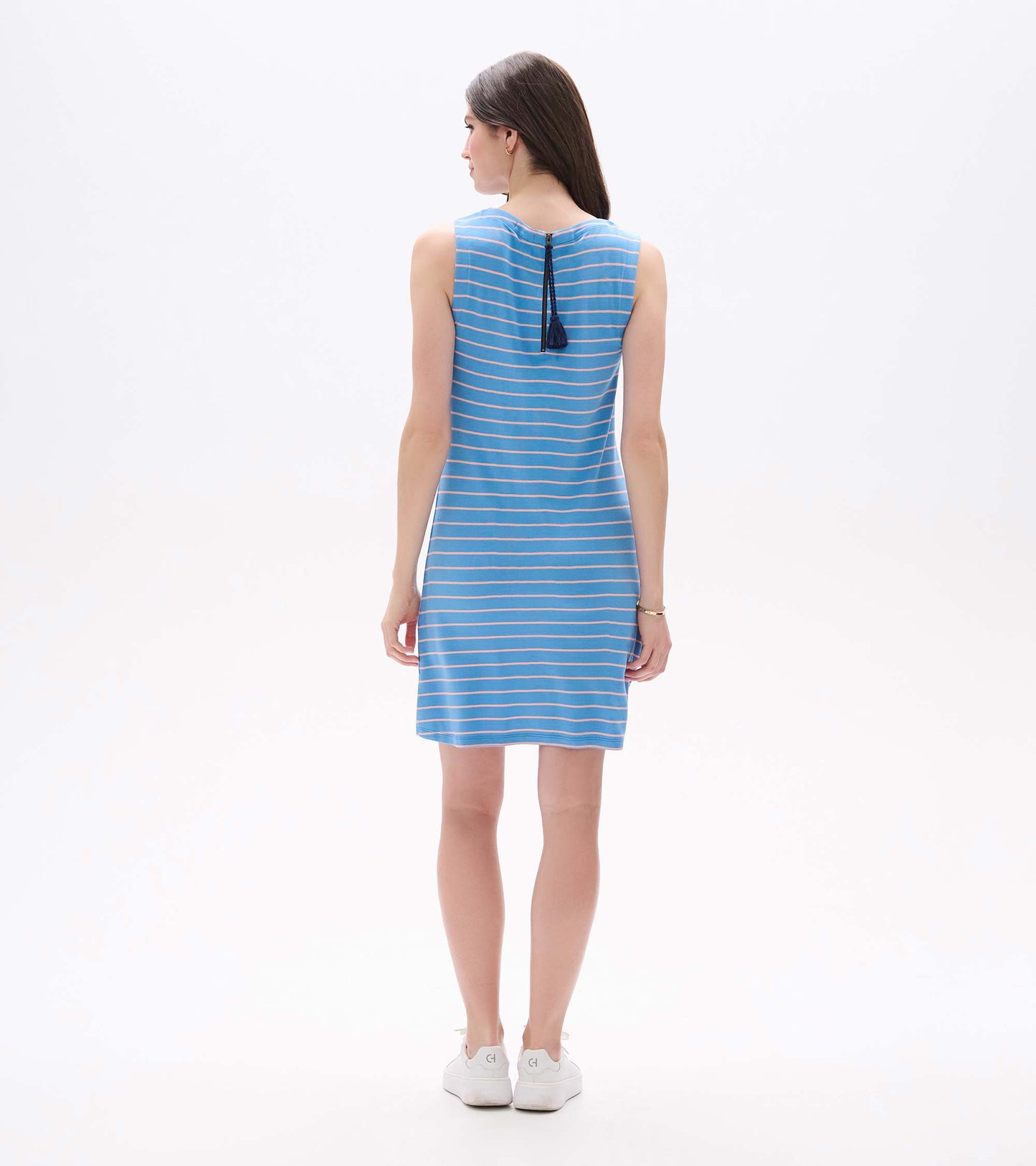 Back view of a sleeveless blue dress with pink horizontal stripes and a zipper with tassel detail