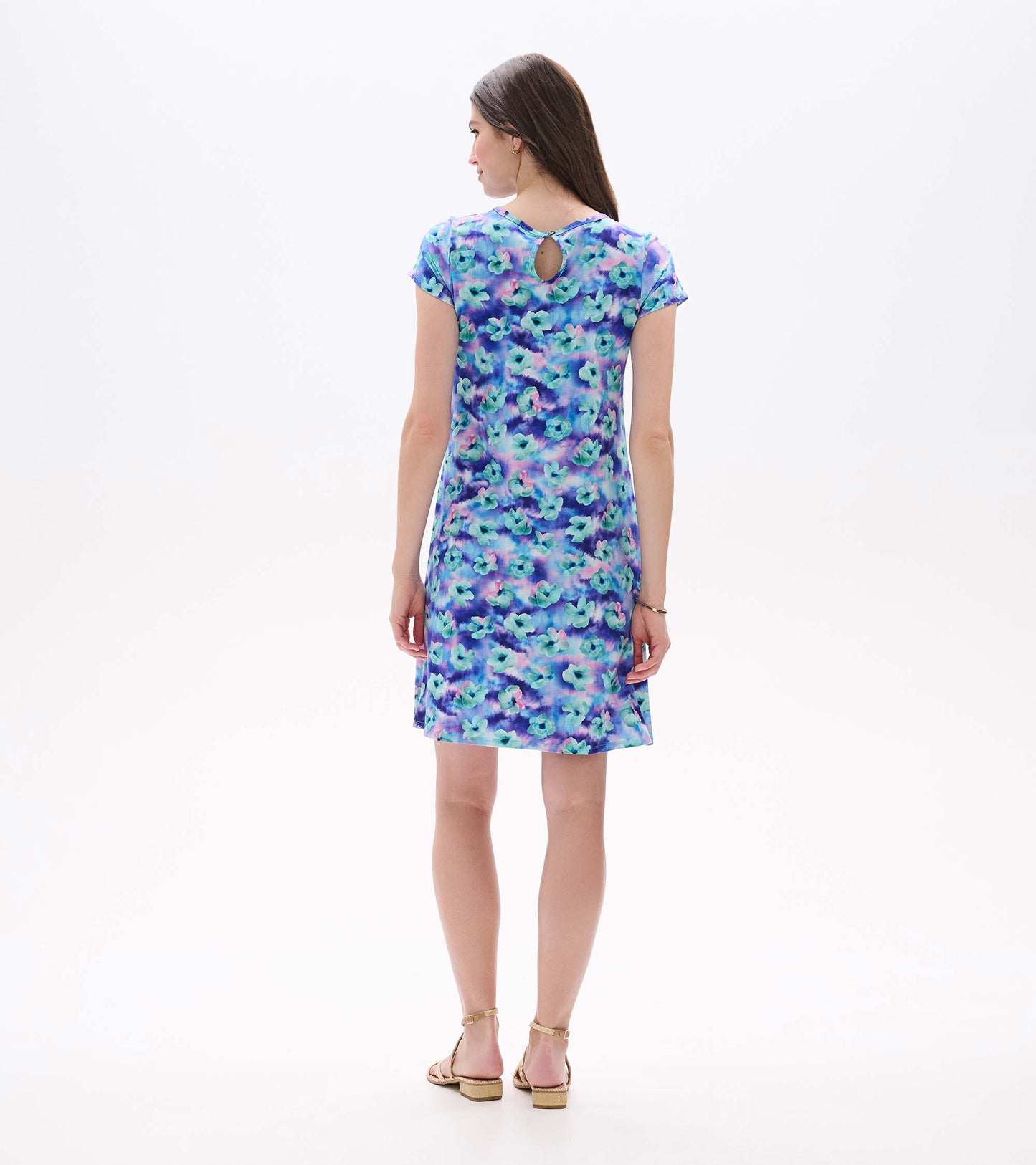 Back view of a short-sleeve A-line dress with blue, purple, and teal floral print and keyhole back detail