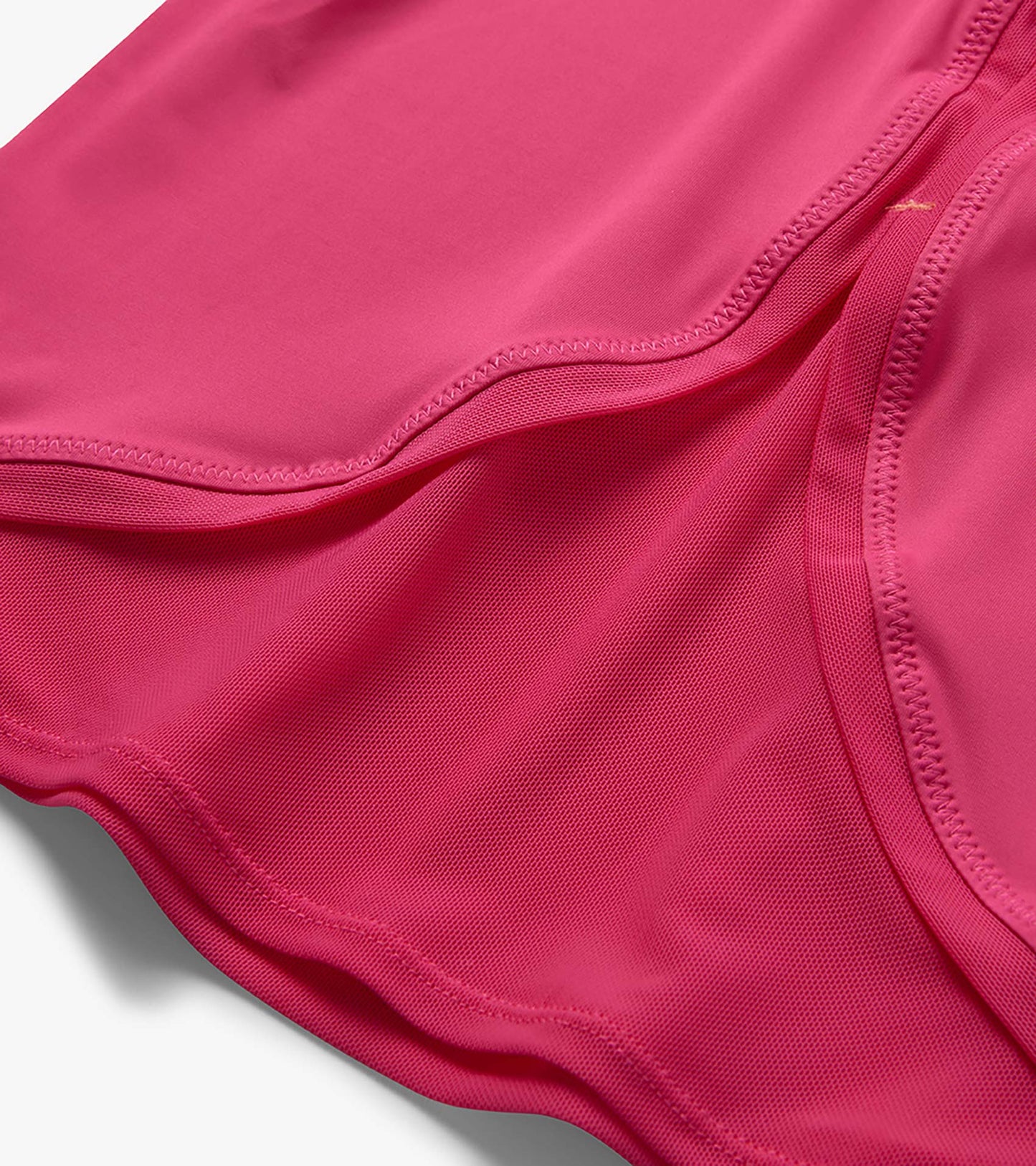 Pink girls' T-shirt with mesh trim and curved hem, close-up detail view