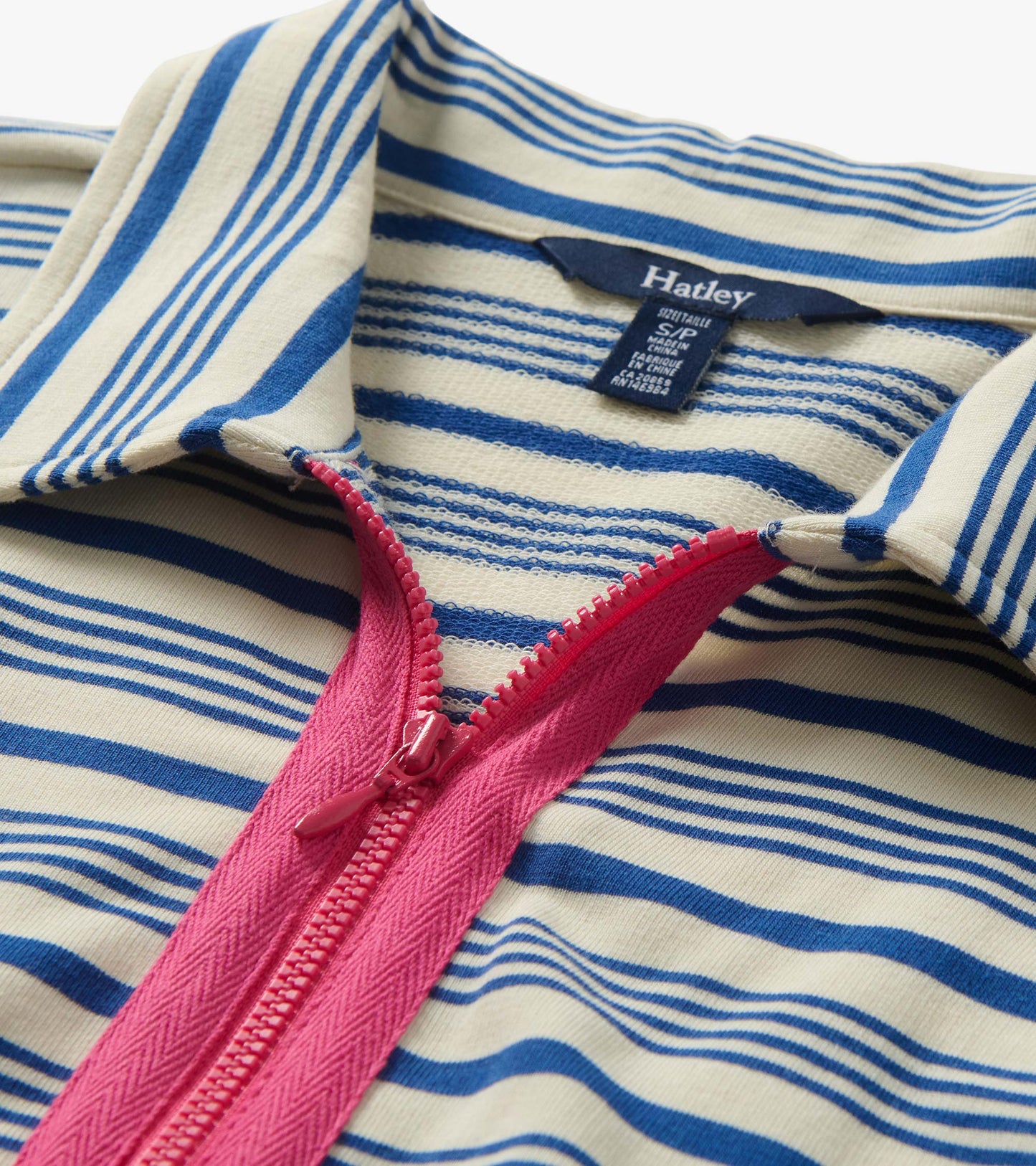 Close-up of cream and blue striped maxi dress with pink front zipper and collar detail