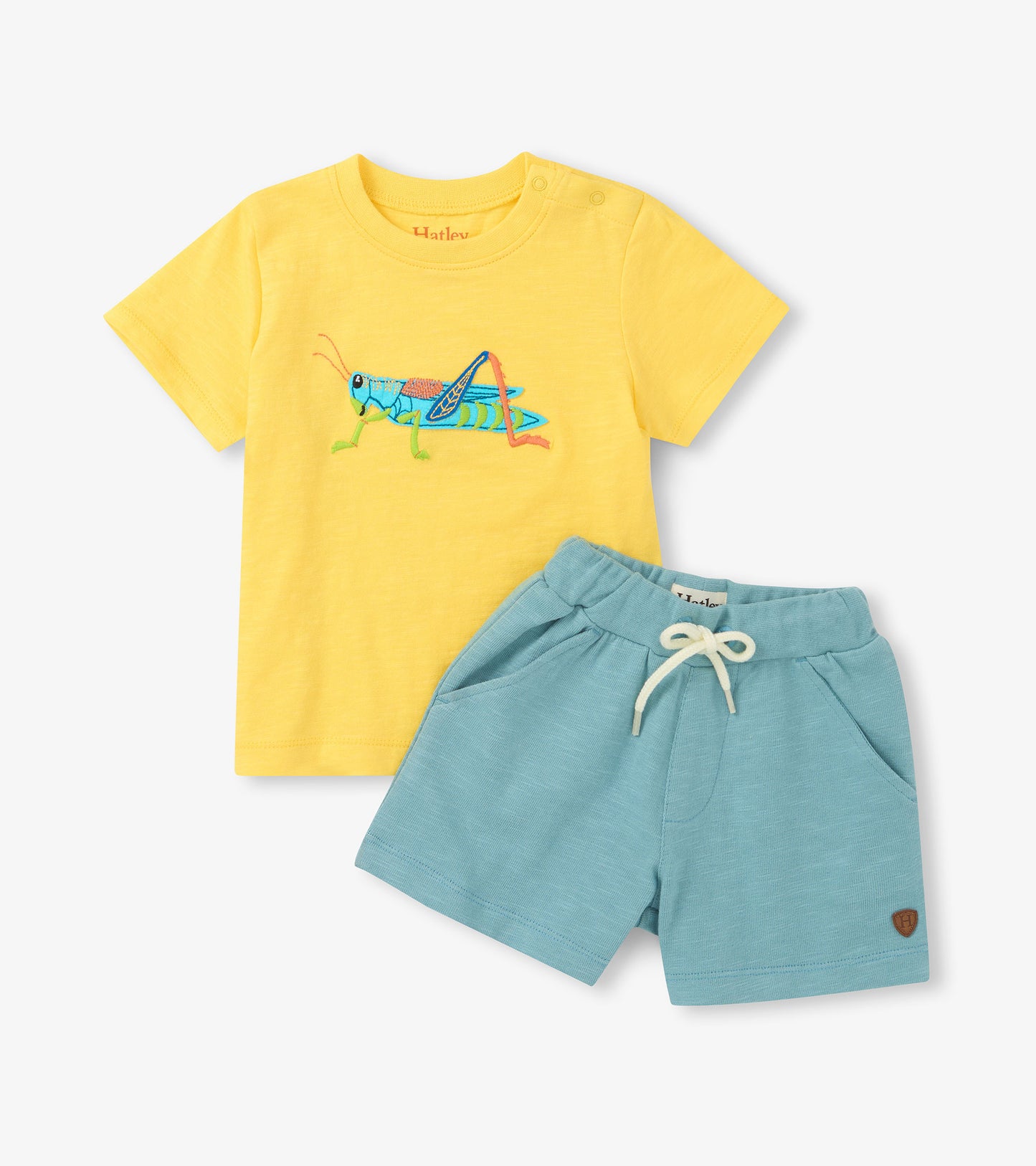 Yellow grasshopper graphic T-shirt with light blue drawstring shorts, shown laid flat