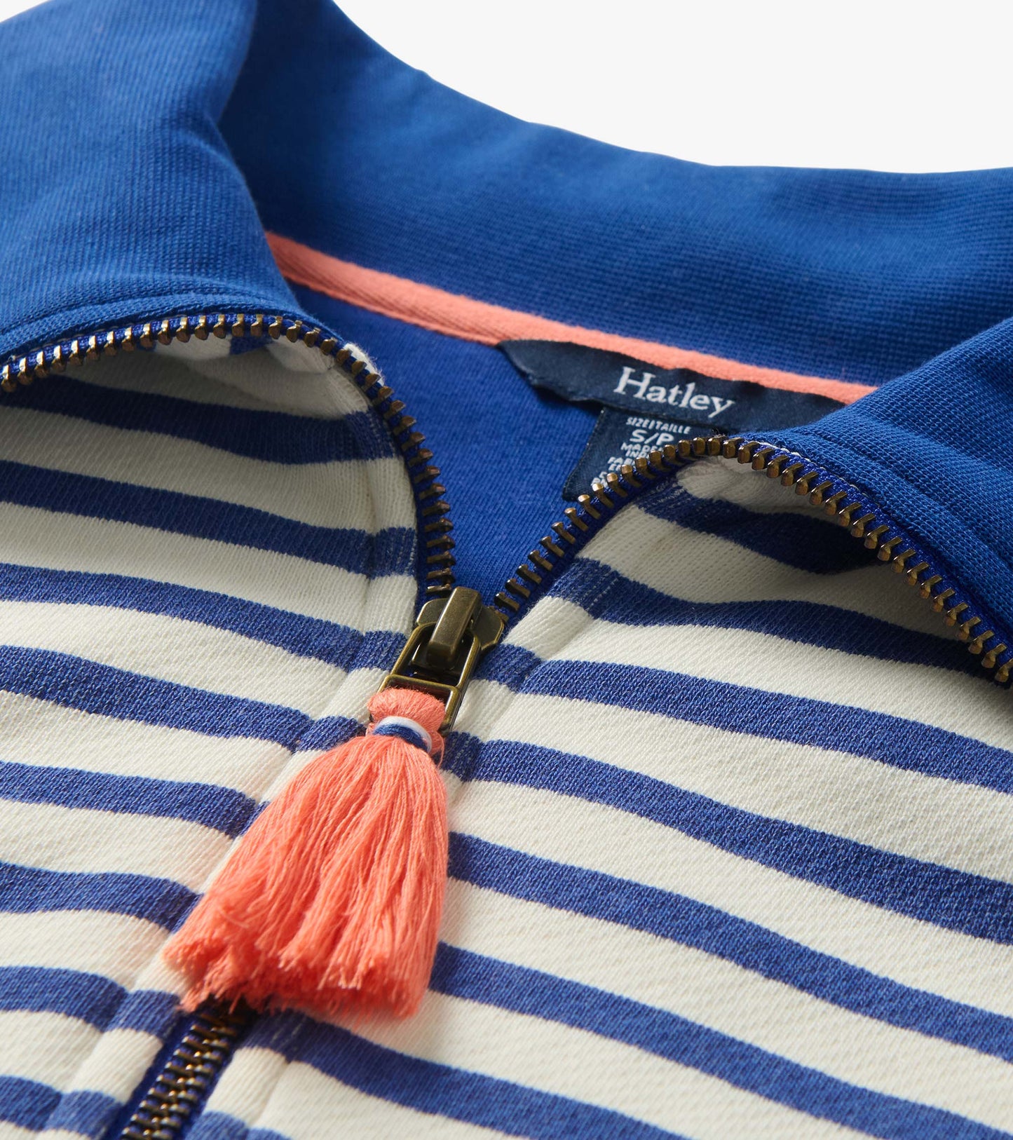 Close-up of blue and white striped quarter-zip pullover with blue collar and coral tassel zipper pull