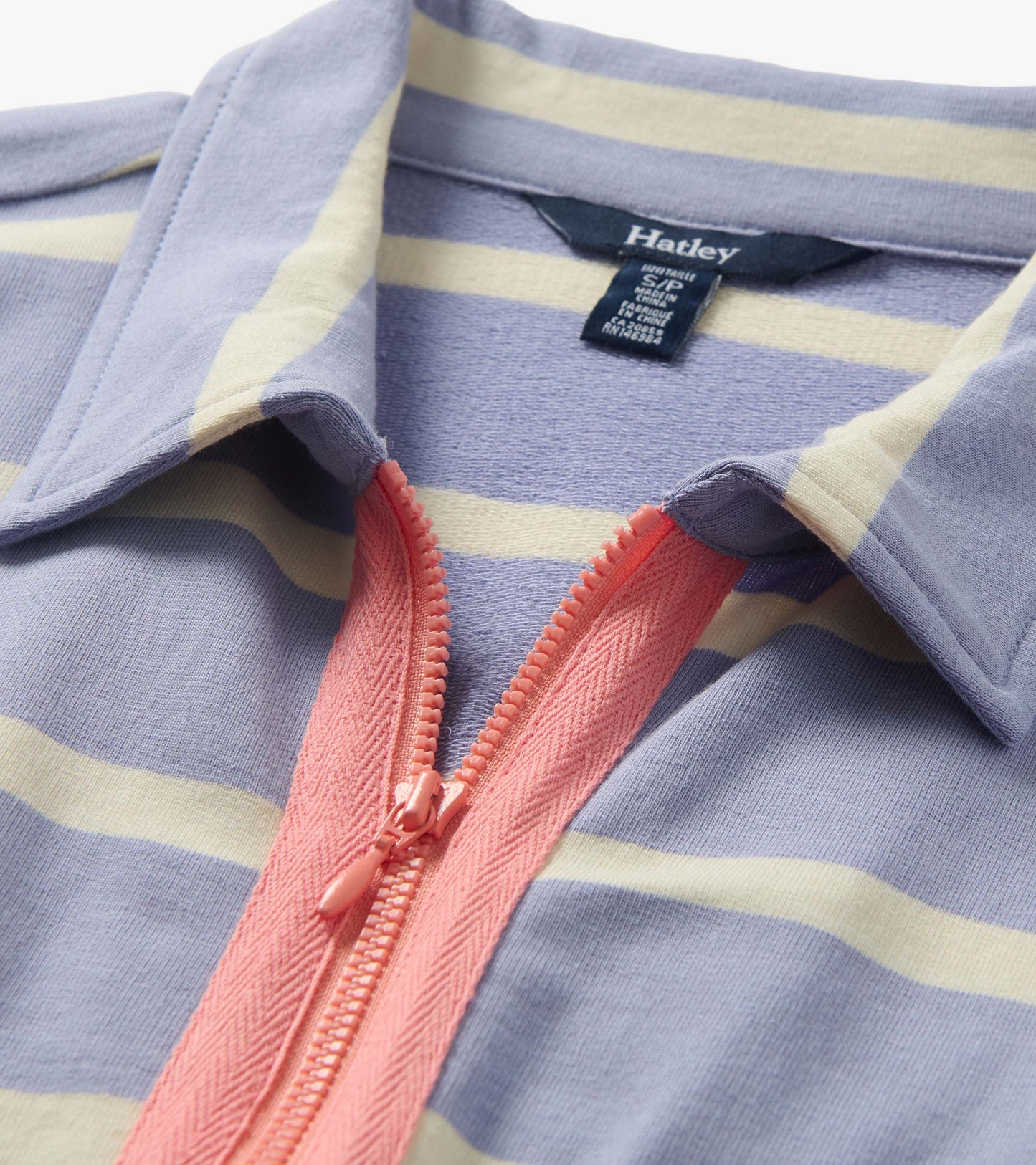 Close-up of a pale blue and cream striped maxi dress with pink contrast zip and collar detail