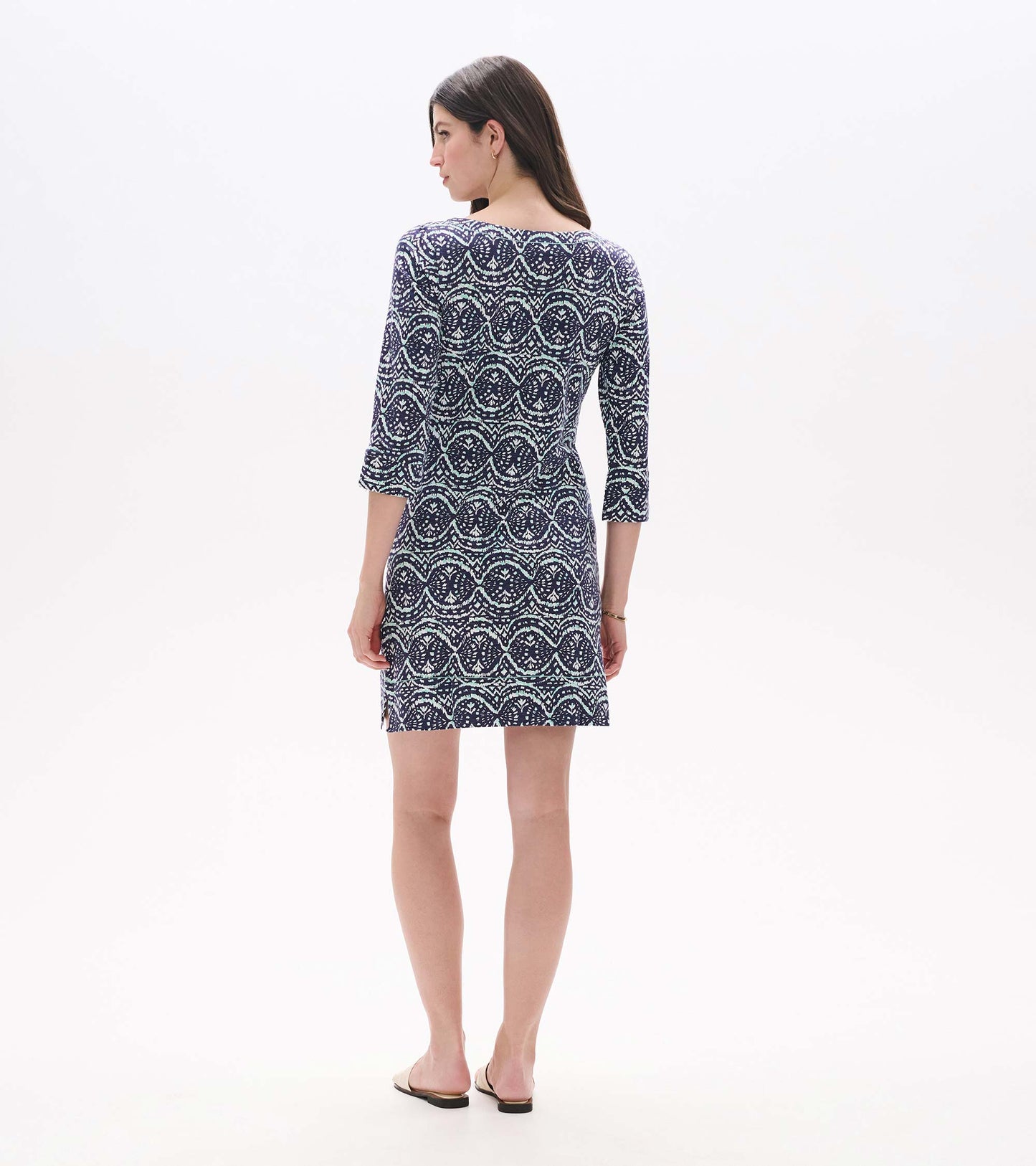 Back view of a navy and mint patterned three-quarter sleeve notch neck dress, above-knee length