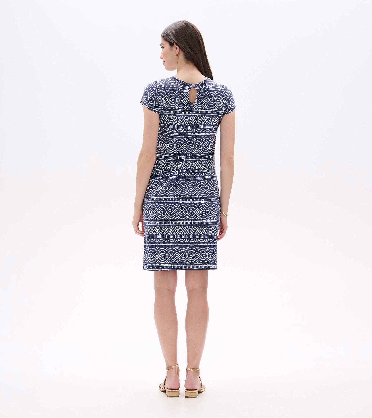 Back view of a navy and white abstract patterned A-line dress with short sleeves and keyhole back detail