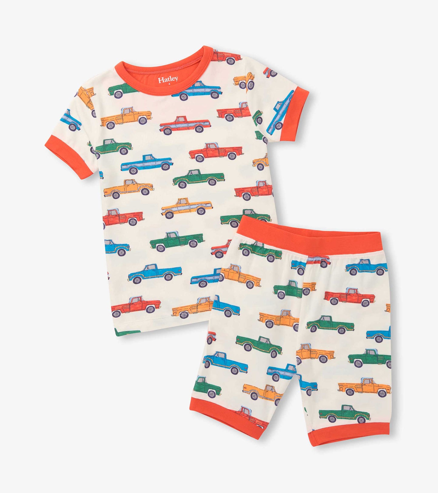 Cream boys short pajama set with colorful pickup truck print and bright orange trim, shown flat