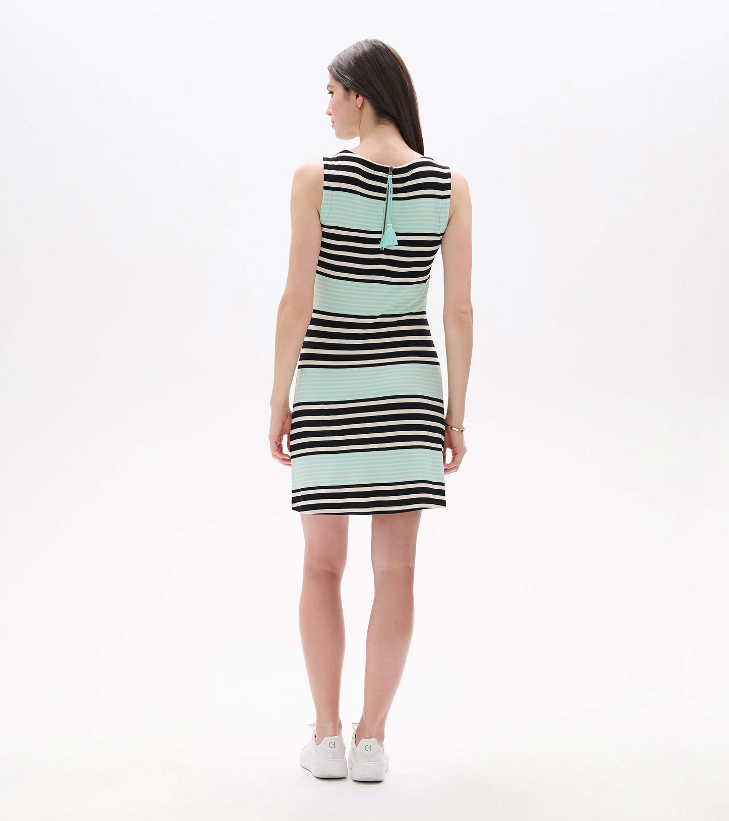 Back view of sleeveless black, white and aqua striped dress with tassel zipper detail, above-knee length