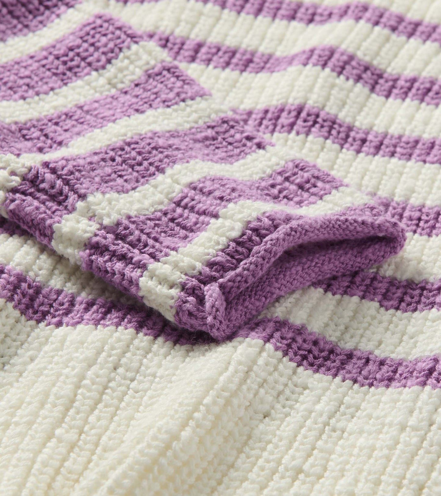 Close-up of ivory and lavender striped knit with rolled cuff detail