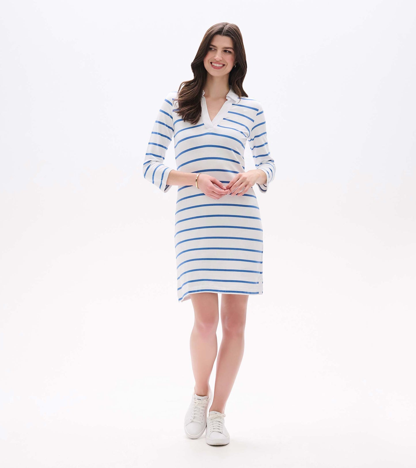 Front angled view of white Taylor dress with blue horizontal stripes, split V-neck collar and side slit