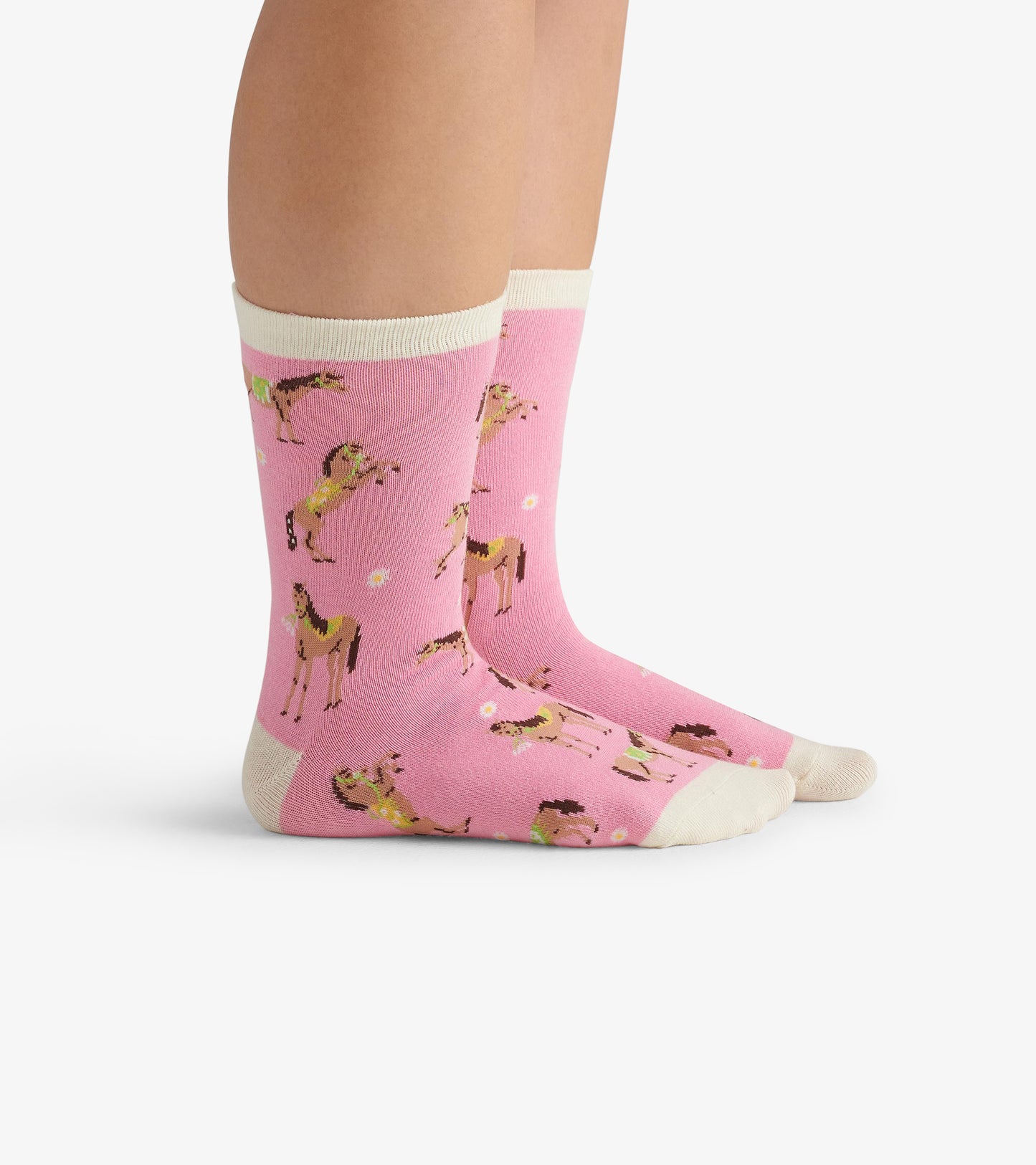 Pink crew socks featuring playful horse patterns and a cream-colored cuff, suitable for casual wear.