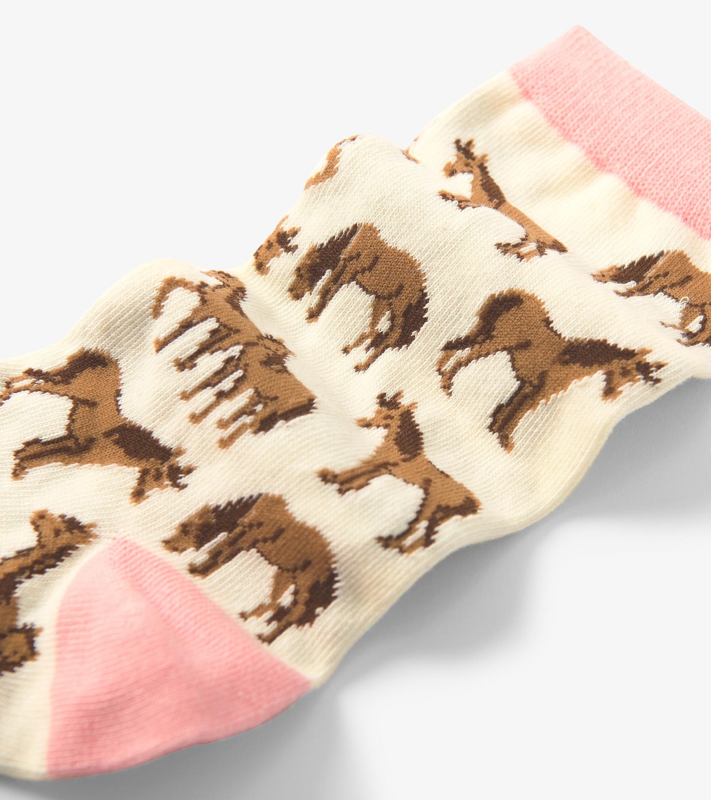 Cream socks featuring a playful horse pattern, with a pink cuff and brown accents. One size fits all.