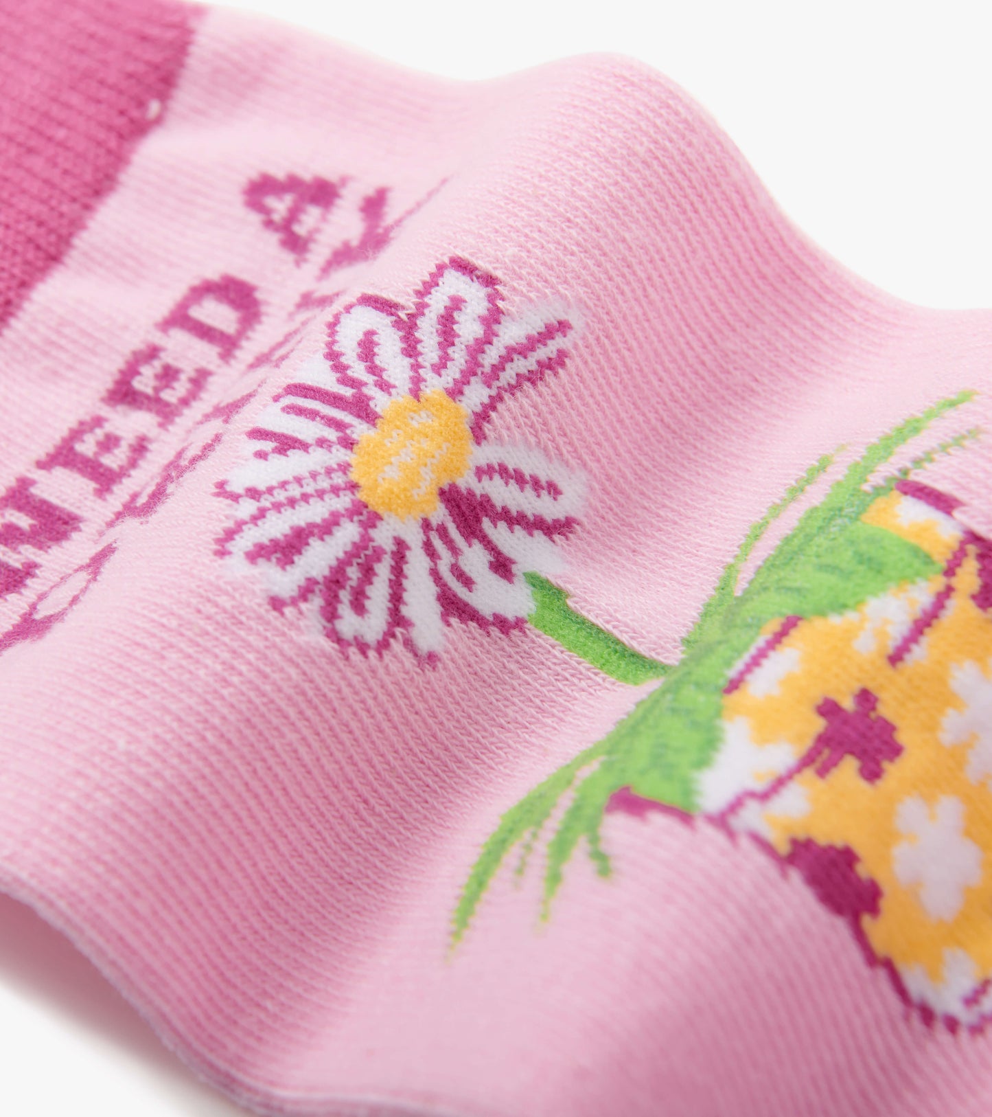 Pink crew socks featuring a floral design with a daisy and a drink motif. Soft material, suitable for casual wear.