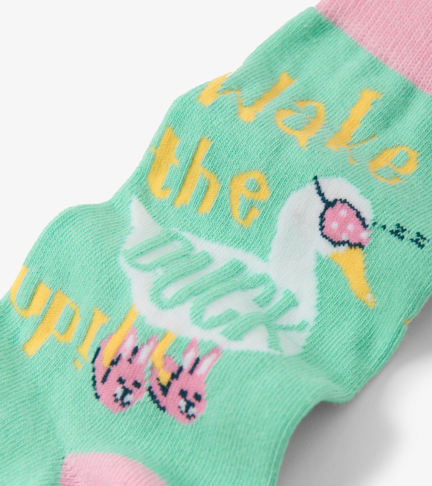 Light green crew socks featuring a duck graphic and playful text, with pink accents and bunny illustrations.