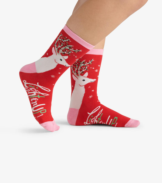 Red crew socks featuring white deer with antlers and pink accents, ideal for casual wear.