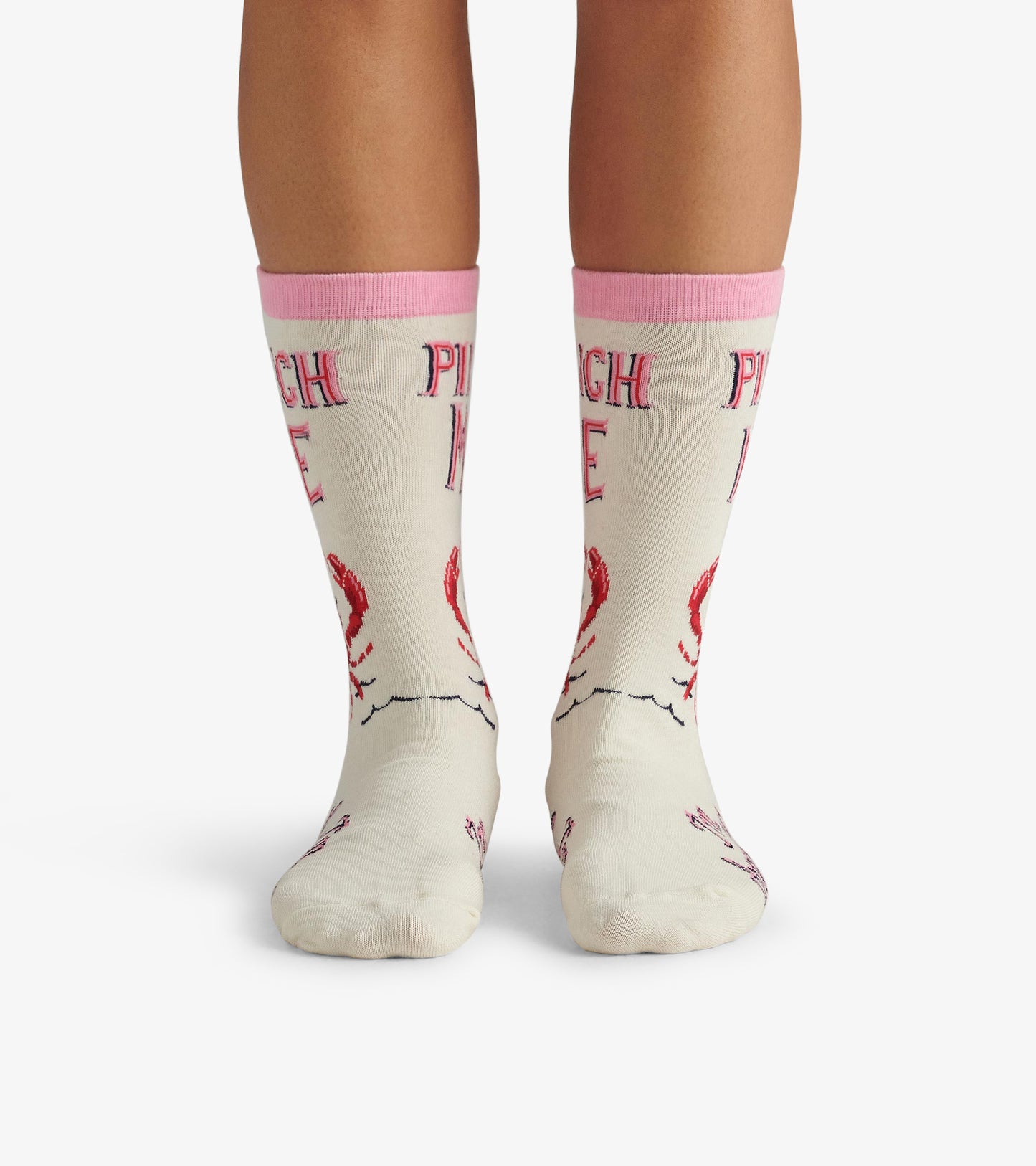 Cream crew socks with pink cuffs, featuring a lobster design and the text "PINCH ME." One size fits most.