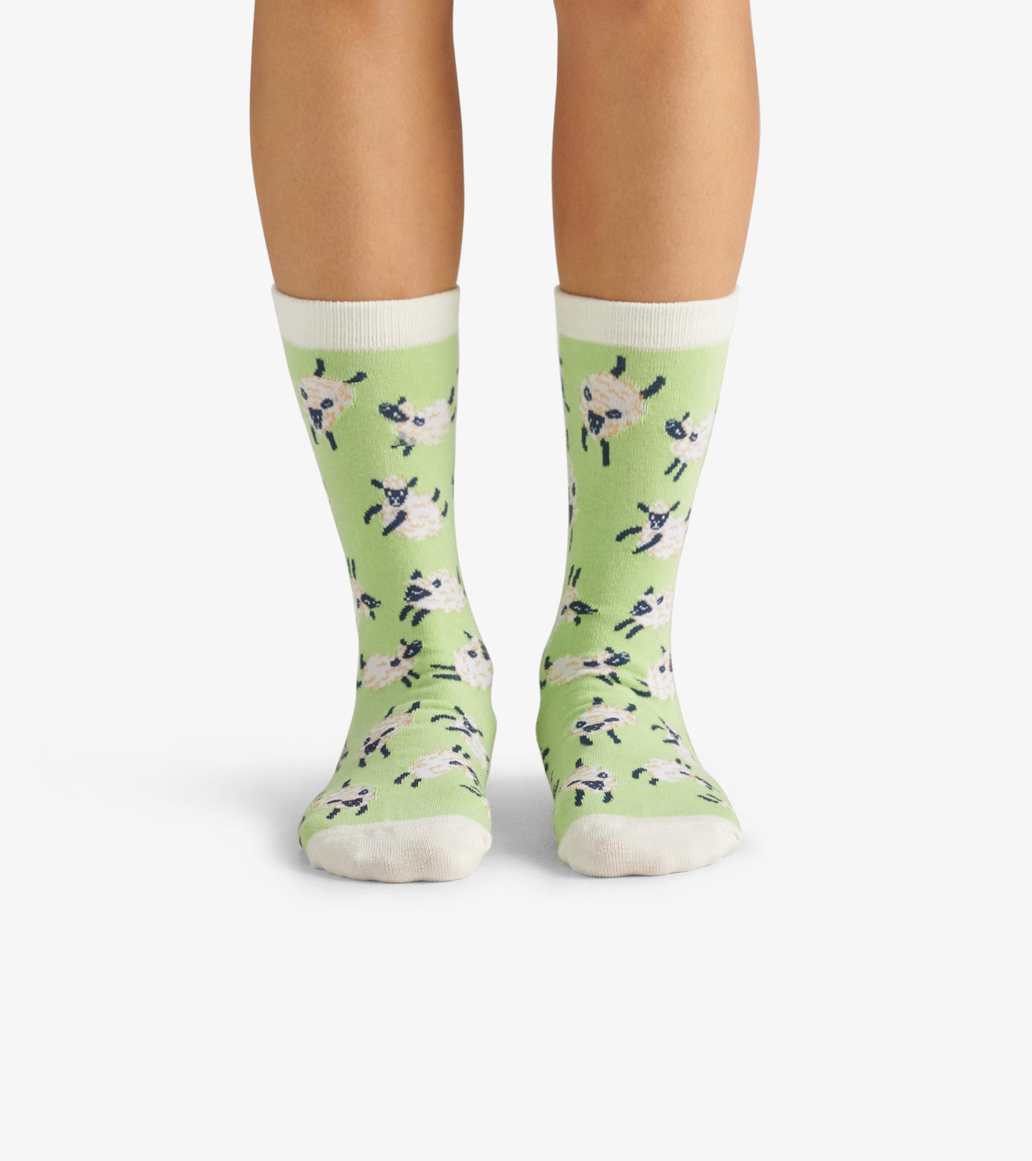 Green crew socks featuring playful sheep patterns, with white cuffs and toes, suitable for casual wear.