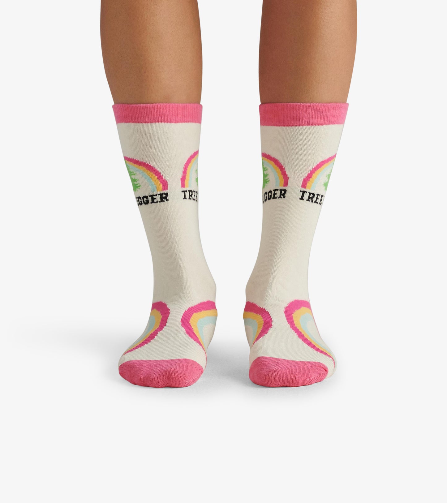 Cream crew socks with pink cuffs, featuring colorful tree and rainbow patterns. One size fits most.