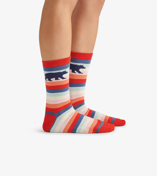 Colorful crew socks featuring stripes in red, blue, and pastel shades with a bear silhouette design. One size fits all.