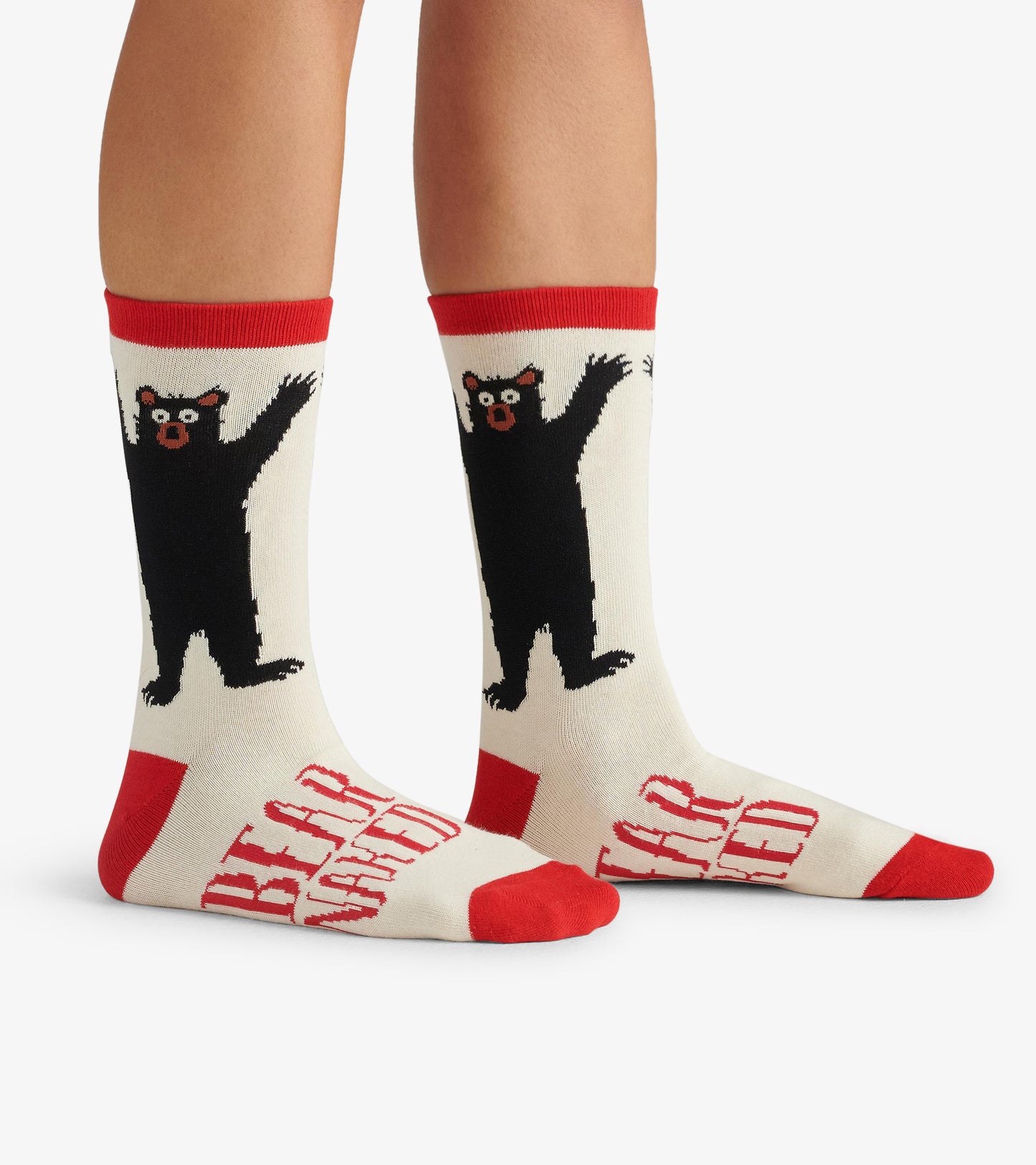 Cream crew socks featuring a black bear design and red accents, ideal for casual wear.