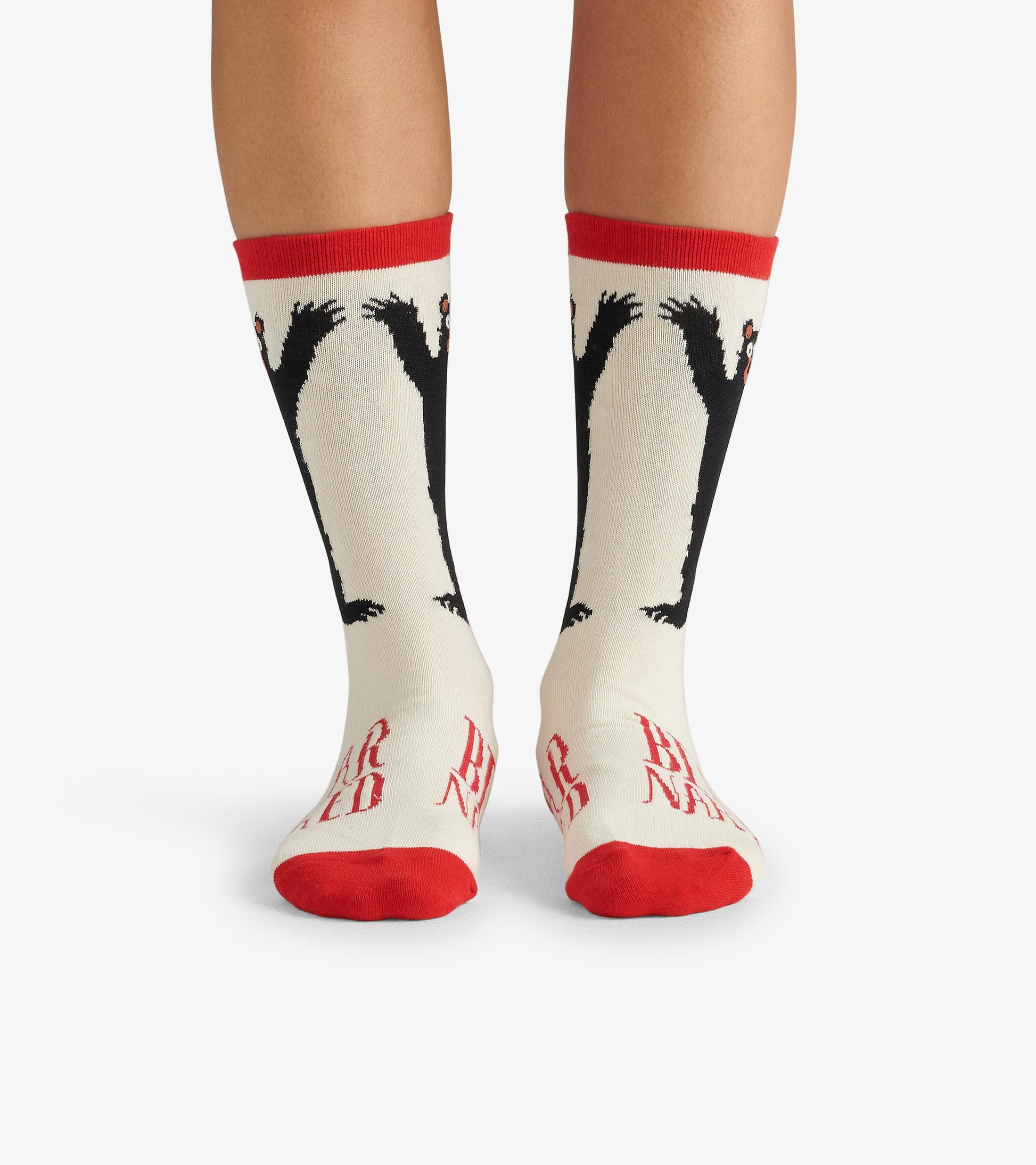 Cream crew socks featuring black bear designs and red accents, perfect for casual wear.