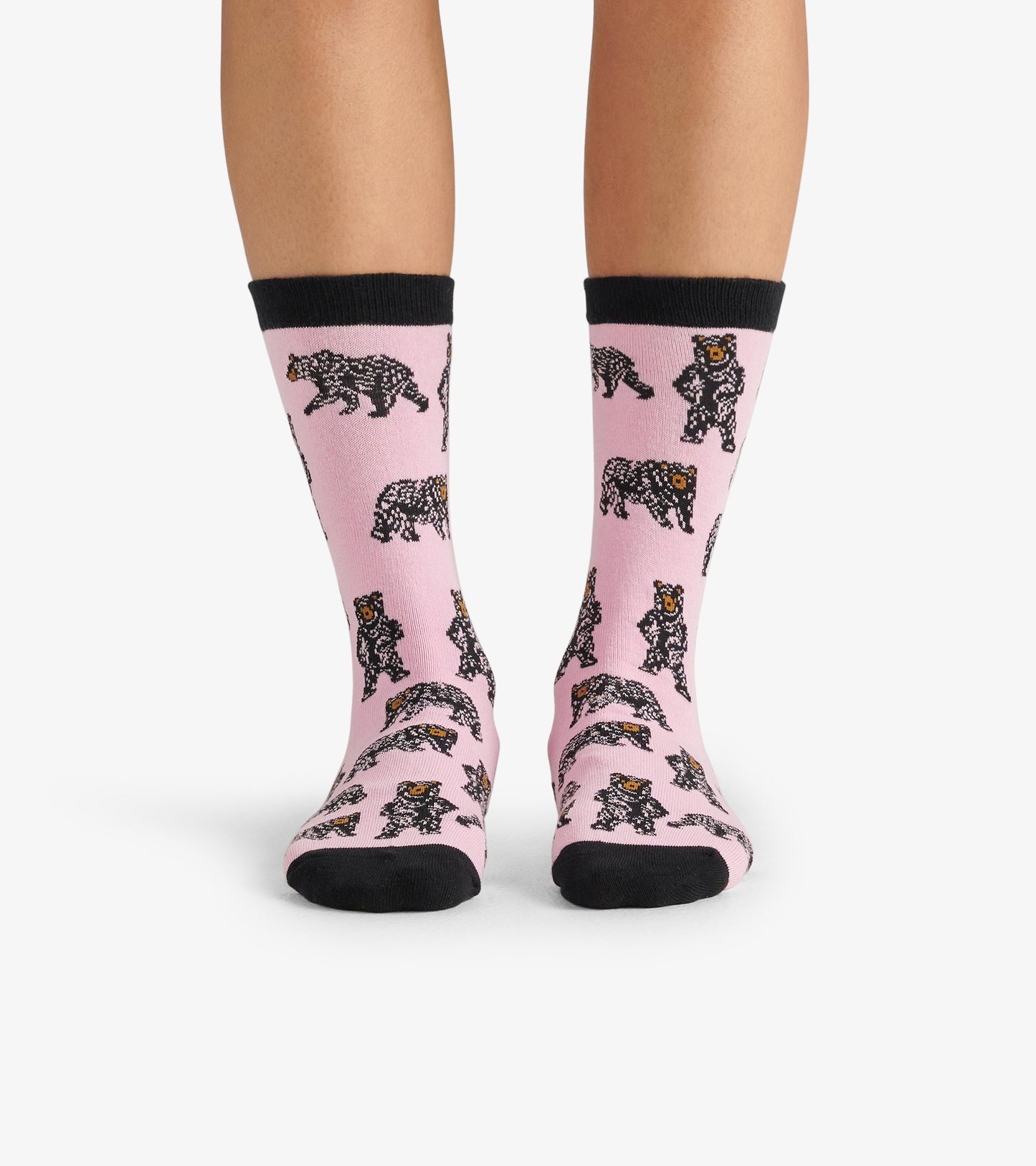 Pink crew socks featuring a playful bear pattern and black accents, suitable for casual wear.