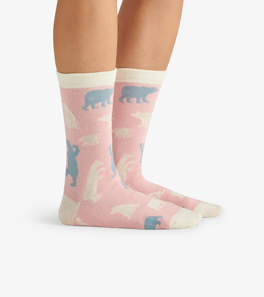 Pink crew socks featuring polar bear patterns in white and blue, with a contrasting cream cuff. One size fits all.