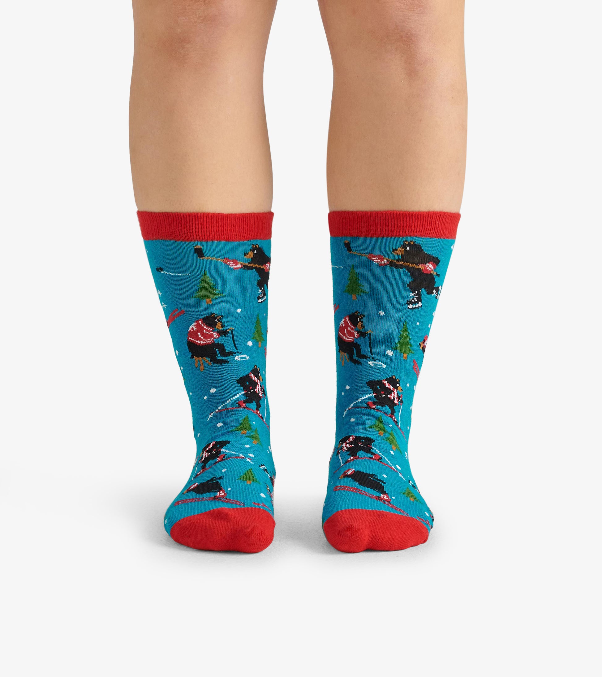 Blue crew socks featuring playful winter scenes with black bears, red accents, and green trees. One size fits all.