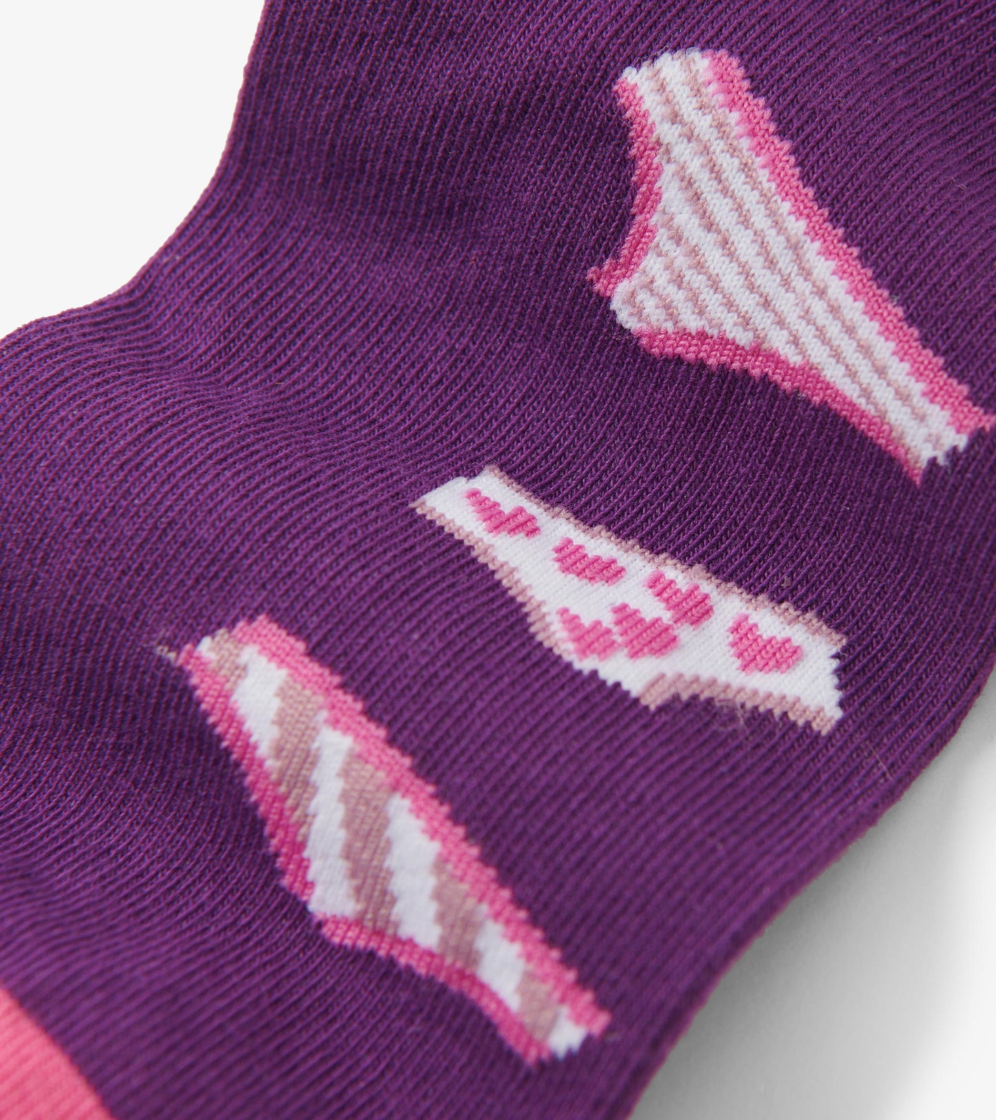 Purple crew socks featuring playful patterns of lingerie in pink and white tones.