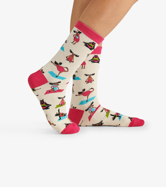 Cream crew socks featuring colorful yoga-themed patterns and pink accents. One size fits most.