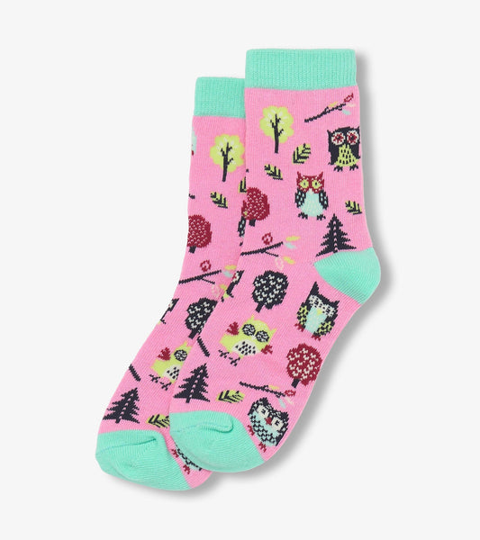 Pink crew socks featuring colorful owl and tree patterns with mint green cuffs and toes. Ideal for kids.