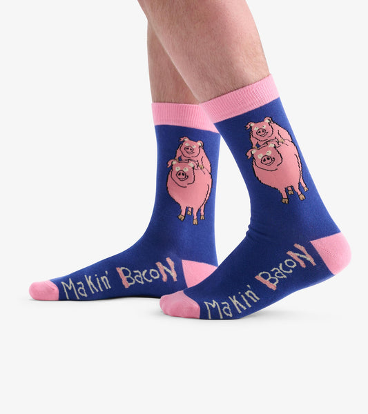 Navy crew socks featuring pink pigs and "Makin' Bacon" text, with pink cuffs and toe accents. One size fits most.