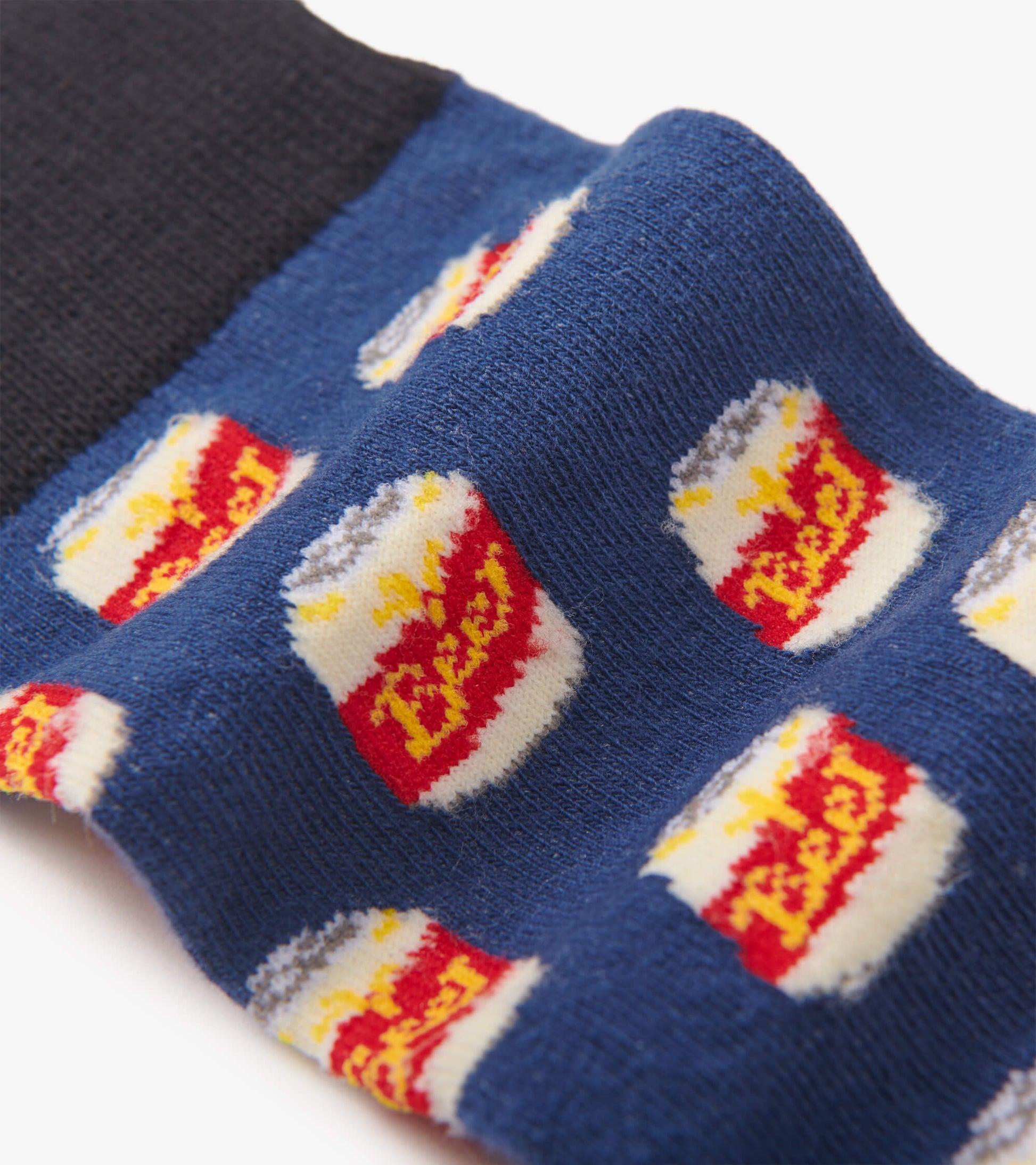 Navy crew socks featuring a playful beer can pattern in red, yellow, and white. One size fits all.
