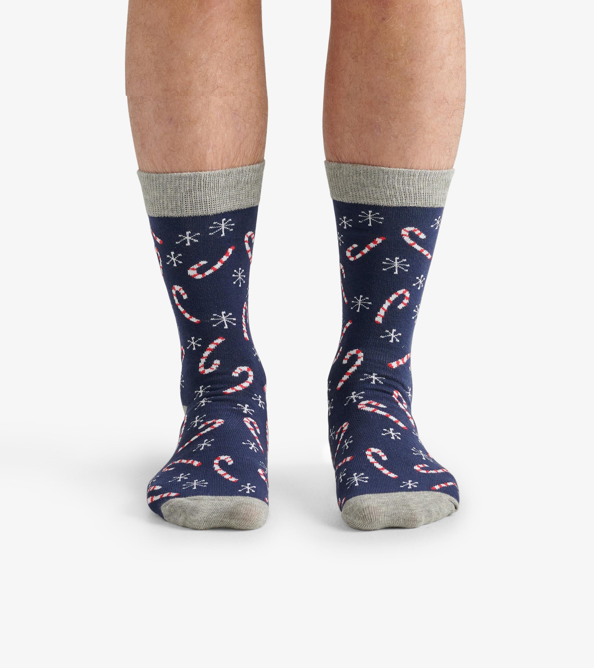 Navy crew socks featuring a candy cane pattern and snowflakes, with a contrasting gray cuff. One size fits most.