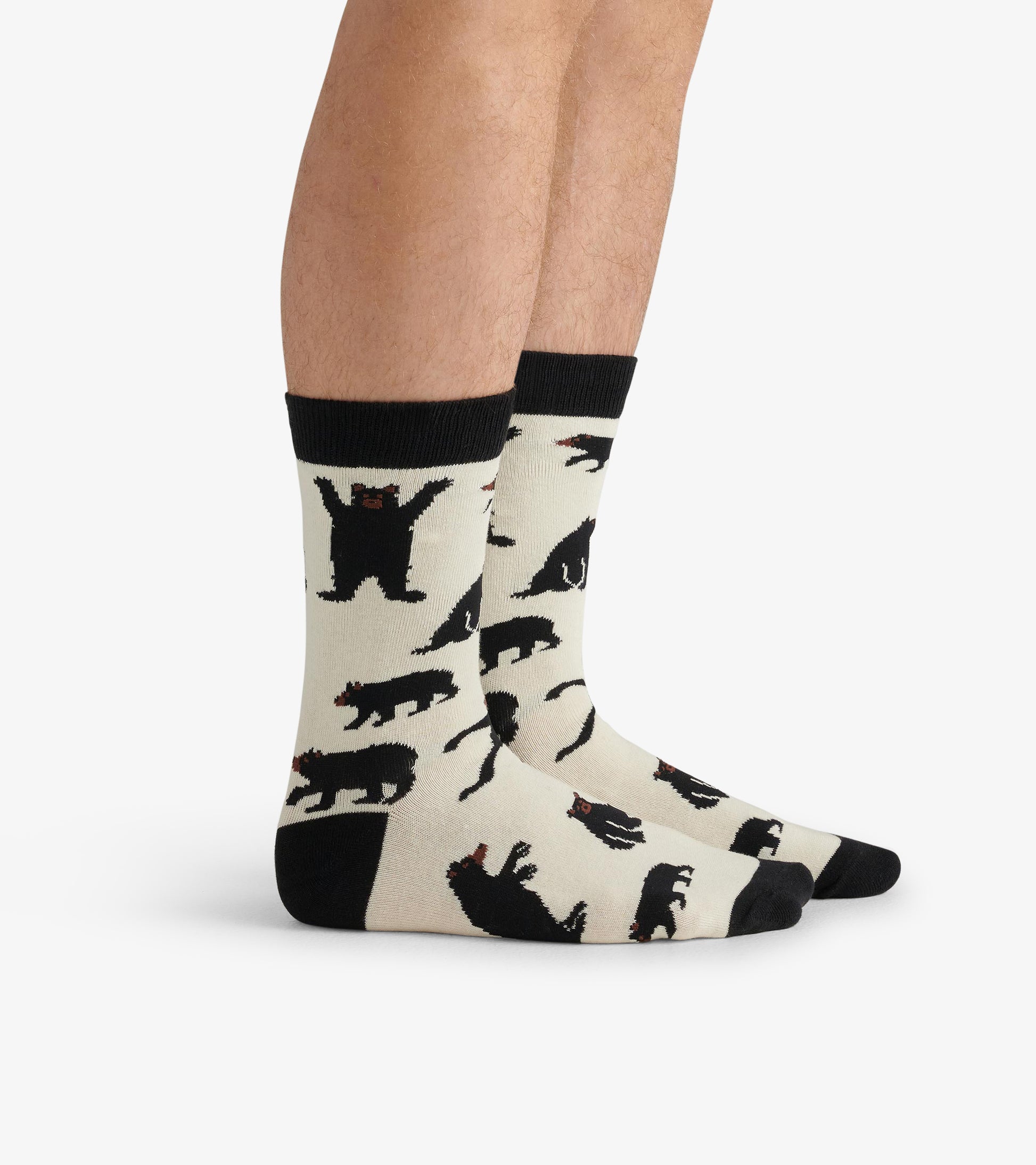 Cream crew socks featuring black bear patterns, with a black cuff and toe, suitable for casual wear.