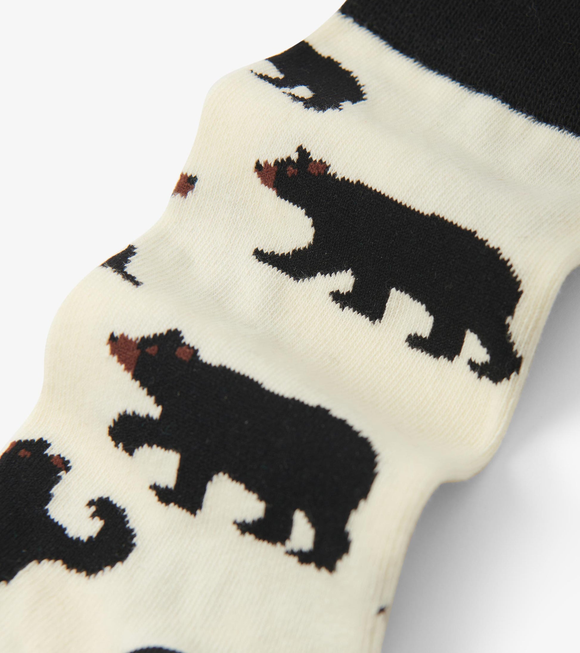 Black crew socks featuring a playful bear pattern on a cream background, made from soft, comfortable material.